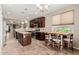 Well-lit kitchen with dark cabinets, stainless steel appliances, and a breakfast nook area at 11023 E Shepperd Ave, Mesa, AZ 85212
