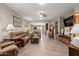 Inviting living room featuring tile floors and an open layout to the kitchen and dining area at 11023 E Shepperd Ave, Mesa, AZ 85212