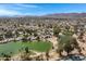 The scenic aerial shot reveals the community's layout with lush golf course and a serene lake enhancing the properties appeal at 12007 S Crow Ct, Phoenix, AZ 85044