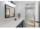Modern bathroom with a shower and blue vanity with a white countertop at 12007 S Crow Ct, Phoenix, AZ 85044