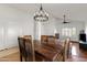 Bright dining room featuring hardwood floors, vaulted ceiling, decorative chandelier, and wooden table at 12007 S Crow Ct, Phoenix, AZ 85044