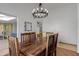 Spacious dining room featuring a wooden table and chandelier lighting; perfect for gatherings at 12007 S Crow Ct, Phoenix, AZ 85044