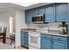 Beautiful kitchen featuring granite counters, modern appliances, and classic blue cabinetry at 12007 S Crow Ct, Phoenix, AZ 85044