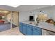 Modern kitchen with blue cabinets, granite countertops, and stainless steel appliances at 12007 S Crow Ct, Phoenix, AZ 85044