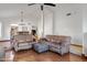 Bright open-plan living room with hardwood floors and vaulted ceilings at 12007 S Crow Ct, Phoenix, AZ 85044