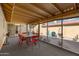 Spacious screened patio with a dining table and view of the outdoor space at 12007 S Crow Ct, Phoenix, AZ 85044