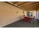 Covered patio with outdoor dining area and a textured wall at 12007 S Crow Ct, Phoenix, AZ 85044