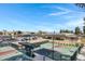 View of the fenced-in pickleball courts, covered seating and parking area at 12007 S Crow Ct, Phoenix, AZ 85044