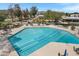 A refreshing swimming pool with lane markers surrounded by lounge chairs offering a perfect spot to relax and soak up the sun at 12007 S Crow Ct, Phoenix, AZ 85044