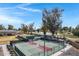 View of well-maintained tennis courts with the green landscaping, providing a scenic and active lifestyle for residents at 12007 S Crow Ct, Phoenix, AZ 85044