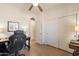 Bright bedroom features ceiling fan, closet, a desk, and dark gaming chair at 1209 E Park Ave, Chandler, AZ 85225