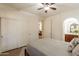 Primary bedroom featuring neutral color palette, ceiling fan, and ensuite bathroom at 1209 E Park Ave, Chandler, AZ 85225