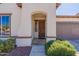 Inviting front entry featuring a decorative door, manicured shrubs, and a charming desert landscape at 1209 E Park Ave, Chandler, AZ 85225