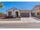 Charming single-story home with a well-maintained front yard, two-car garage, and a desert landscape at 1209 E Park Ave, Chandler, AZ 85225