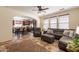 Open-concept living room with large windows, ceiling fan, and an adjacent dining area and kitchen at 1209 E Park Ave, Chandler, AZ 85225