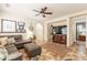 Cozy living room with a ceiling fan, decorative tile flooring, and an entertainment center at 1209 E Park Ave, Chandler, AZ 85225