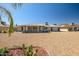 Expansive backyard showcasing low-maintenance landscaping, desert flora, and a covered patio area at 13114 W Castlebar Dr, Sun City West, AZ 85375