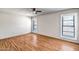 Bright and airy bedroom featuring light hardwood floors and shuttered windows, providing natural light at 13114 W Castlebar Dr, Sun City West, AZ 85375