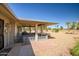 Inviting covered patio offering views of a well-manicured yard and a golf course in the distance at 13114 W Castlebar Dr, Sun City West, AZ 85375