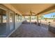 Spacious covered patio boasts neutral colors, brick accents, and golf course views at 13114 W Castlebar Dr, Sun City West, AZ 85375