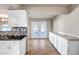 Bright kitchen with stainless steel appliances and white cabinets opens to the eating area at 13114 W Castlebar Dr, Sun City West, AZ 85375