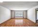 Bright living room boasts wood flooring and large window offering natural light at 13114 W Castlebar Dr, Sun City West, AZ 85375