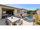 Inviting backyard with a refreshing pool, comfortable dining area, and seamless transition to an indoor living space at 13418 W Mayberry Trl, Peoria, AZ 85383