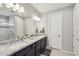 Elegant bathroom with double sinks, granite countertops, and a glass-enclosed shower for a luxurious experience at 13418 W Mayberry Trl, Peoria, AZ 85383