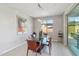 Modern dining room with a glass table, contemporary chairs, and a view of the backyard through a sliding glass door at 13418 W Mayberry Trl, Peoria, AZ 85383