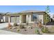 Charming one-story home with a well-manicured desert landscaped front yard and an attached two-car garage at 13418 W Mayberry Trl, Peoria, AZ 85383