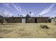 Backyard view of home, including brick and siding exterior and blue skies at 1518 N Gilbert Ave, Casa Grande, AZ 85122
