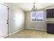 Dining room featuring chandelier, window with blinds, and access to kitchen, with tile floors at 1518 N Gilbert Ave, Casa Grande, AZ 85122