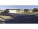 Front exterior view of single-story home featuring attached garage, desert landscaping, and classic design at 1518 N Gilbert Ave, Casa Grande, AZ 85122