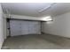 Spacious two car garage with a white door and light fixtures at 1518 N Gilbert Ave, Casa Grande, AZ 85122