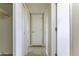 Hallway with neutral walls and tile floors, showcasing access to multiple rooms and closet space at 1518 N Gilbert Ave, Casa Grande, AZ 85122