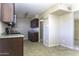 Kitchen featuring dark wood cabinets, light countertops, stainless steel appliances, and tile floors at 1518 N Gilbert Ave, Casa Grande, AZ 85122