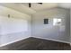 Unfinished shed interior featuring a new electrical panel and wood-look flooring at 1518 N Gilbert Ave, Casa Grande, AZ 85122