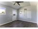 Unfinished shed interior with modern ceiling fan, AC, new flooring and a door with glass at 1518 N Gilbert Ave, Casa Grande, AZ 85122