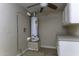 Utility room with water heater and upper and lower cabinets for storage at 1518 N Gilbert Ave, Casa Grande, AZ 85122