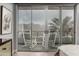 Bedroom view of balcony with rocking chairs and sliding glass doors with a mountain range in the background at 16580 N 92Nd St # 2003, Scottsdale, AZ 85260