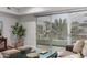 View from the living room to the balcony with sliding glass doors and potted plants and outdoor furniture at 16580 N 92Nd St # 2003, Scottsdale, AZ 85260