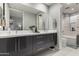 Elegant bathroom featuring a double vanity, sleek cabinets, and a tiled shower at 16580 N 92Nd St # 2003, Scottsdale, AZ 85260