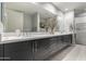 Modern bathroom featuring double vanity, large mirror, and glass enclosed shower at 16580 N 92Nd St # 2003, Scottsdale, AZ 85260