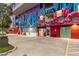 Building exterior showing the colorful mural and a paved parking area at 16580 N 92Nd St # 2003, Scottsdale, AZ 85260