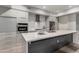 Modern kitchen features a large island, stainless steel appliances, and sleek cabinetry with a contemporary backsplash at 16580 N 92Nd St # 2003, Scottsdale, AZ 85260