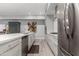 Modern kitchen with white cabinets, stainless steel appliances, and a center island with a sink and dishwasher at 16580 N 92Nd St # 2003, Scottsdale, AZ 85260
