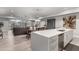 Bright, open-concept living space with modern kitchen, dining area, and comfortable seating featuring light wood floors at 16580 N 92Nd St # 2003, Scottsdale, AZ 85260