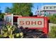 Exterior sign that reads 'SOHO' in front of desert landscaping at 16580 N 92Nd St # 2003, Scottsdale, AZ 85260