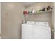 Bright laundry room with a modern washer and dryer, plus built-in shelving at 17017 N 12Th St # 1106, Phoenix, AZ 85022