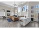 Open-concept living room with high ceilings, a fireplace, a kitchen island, and large windows at 17017 N 12Th St # 1106, Phoenix, AZ 85022